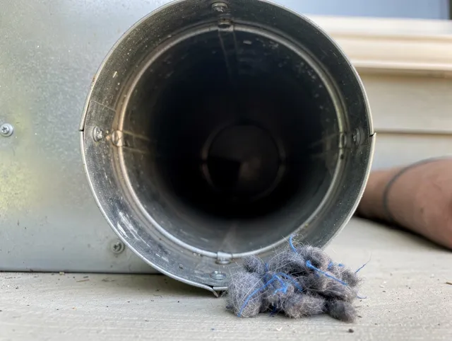 Ridgefield Dryer Vent Cleaning technician using specialized equipment to clear severe dryer vent blockage in Ridgefield